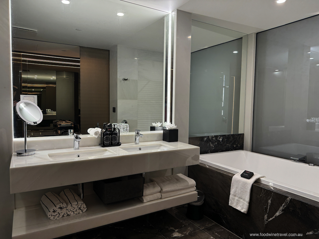 The spacious bathroom has a double vanity and generously proportioned tub.