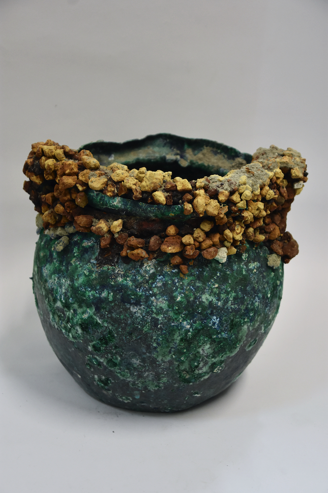 Situla encrusted with lapilli (dried lava stones). The vessel probably stored wine for communal dining.