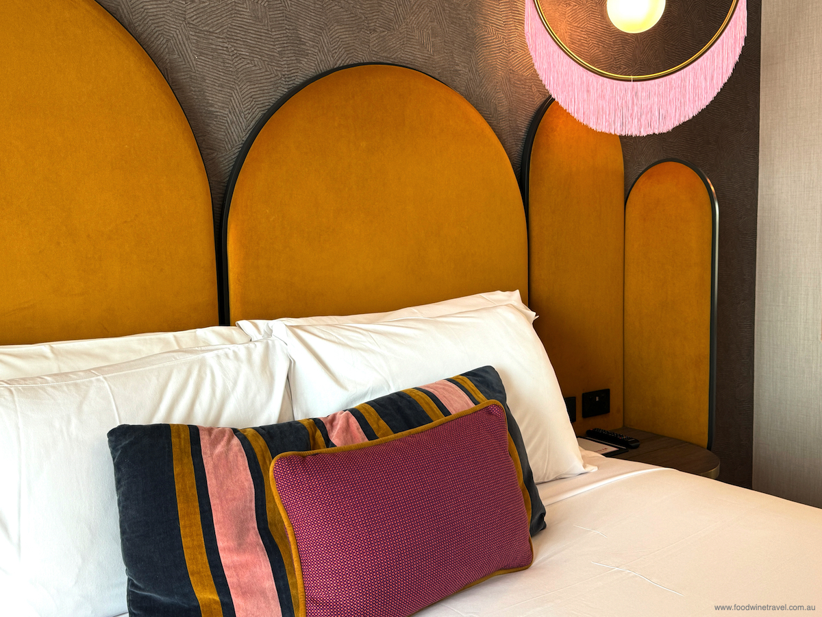 Pops of colour around the king-sized bed add to the show-stopping décor. 